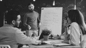 Team aziendale riunito davanti a una lavagna per la pianificazione del personale e la definizione della strategia HR.